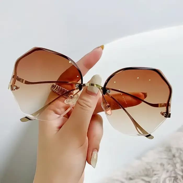 Lunettes de soleil de luxe UV400 pour femmes, verres d'océan, sans bords, branches incurvées en méta